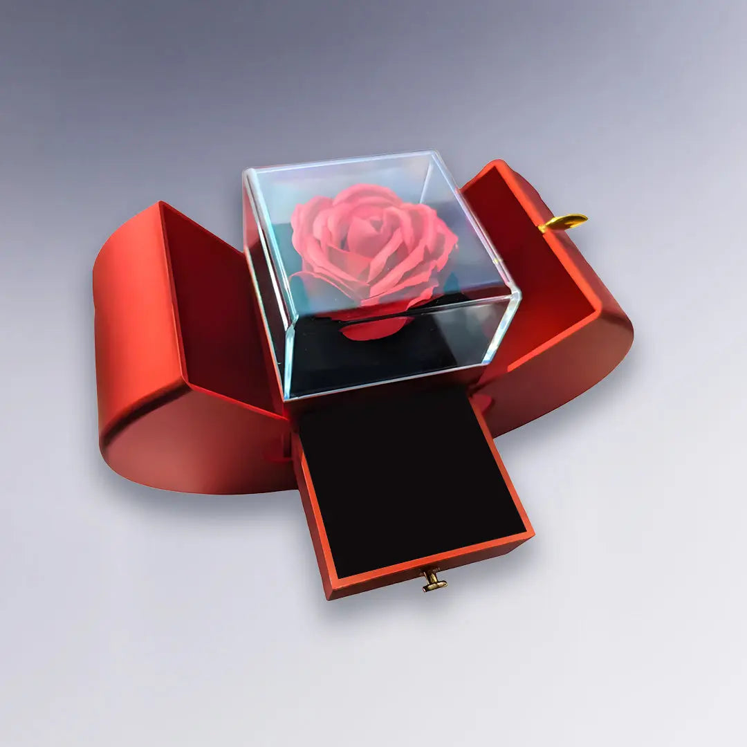Coffret rouge ouvert avec tiroir et rose éternelle sous cloche en verre. Cadeau chic et intemporel pour exprimer son amour ou son attachement.