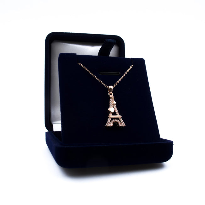 Pendentif Tour Eiffel Cœur en métal doré rose orné de cristaux brillants, présenté dans un écrin bleu nuit personnalisable.