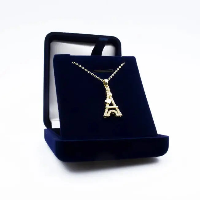 Écrin cadeau contenant un pendentif Tour Eiffel Cœur plaqué or, décoré de cristaux scintillants, parfait pour offrir.