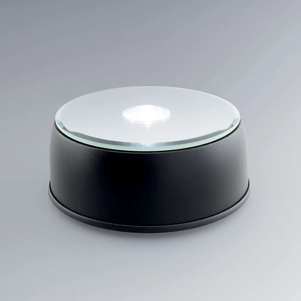 Socle lumineux rotatif à LED blanc et couleurs pour blocs en verre gravés 3D. Parfait pour exposer vos gravures personnalisées avec un éclairage dynamique.