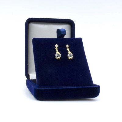 Boucles dorées avec Tour Eiffel sertie de cristaux Swarovski®, livrées dans un coffret bleu nuit. Cadeau chic et élégant à personnaliser.