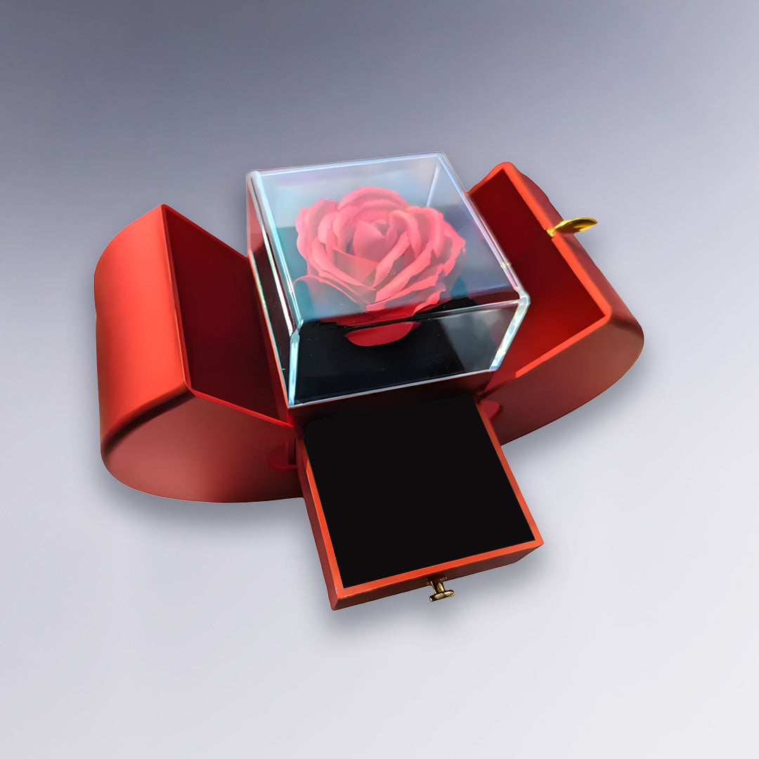 Coffret rouge ouvert avec tiroir et rose éternelle sous cloche en verre. Cadeau chic et intemporel pour exprimer son amour ou son attachement.
