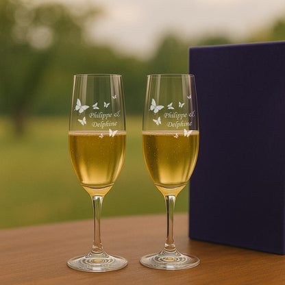 Duo de flûtes à champagne gravées au laser avec papillons et prénoms. Parfait pour trinquer en amoureux ou fêter un moment unique à deux.