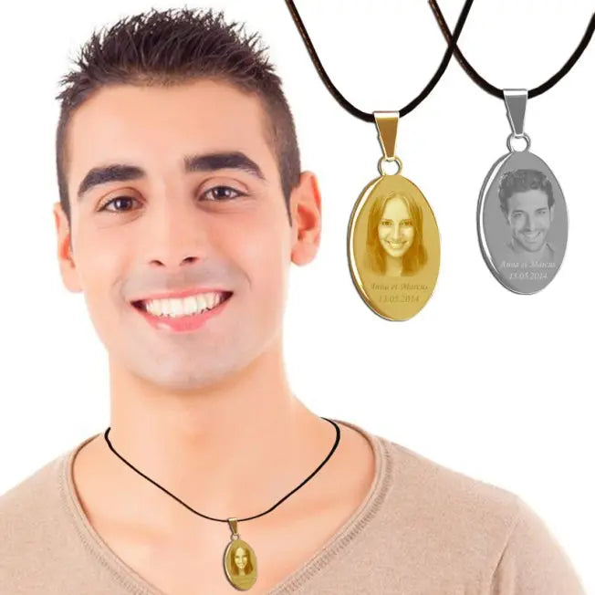 Homme souriant portant un pendentif ovale doré personnalisé avec photo, accompagné des versions or et argent suspendues sur cordons noirs en arrière-plan.