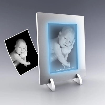 Portrait de naissance gravé dans un cadre lumineux vertical en verre, avec prénom et date, éclairage LED bleuté.