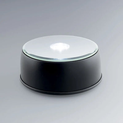 Socle lumineux rotatif à LED blanc et couleurs pour blocs en verre gravés 3D. Parfait pour exposer vos gravures personnalisées avec un éclairage dynamique.